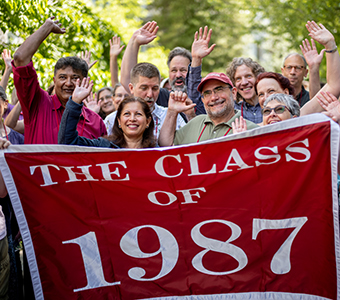 Photo of people holding a Class of 1987 sign. 
