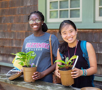 Photo of two students holding potted plants. Links to Gifts of Appreciated Securities